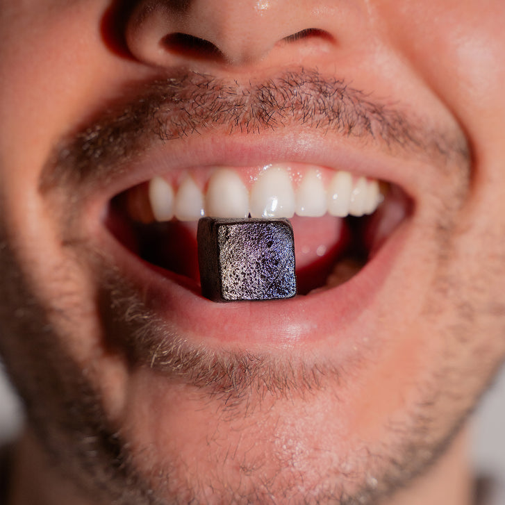 Close-up of a person's mouth with a gummy inside
