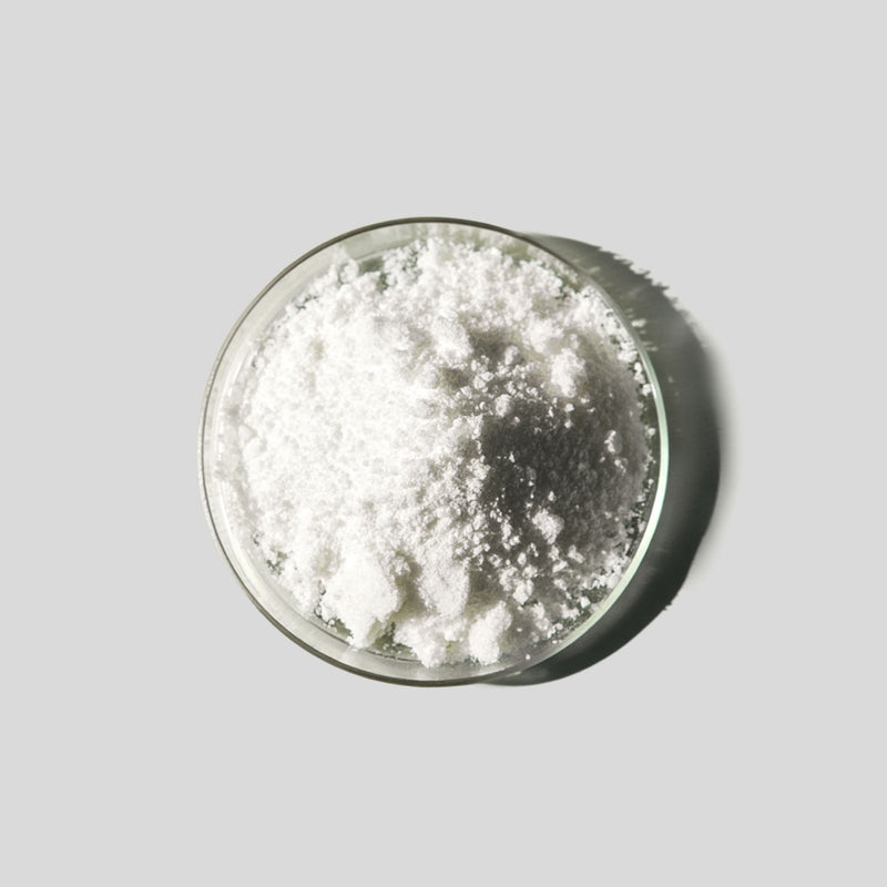 White powdery substance in a glass container on a gray background
